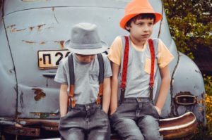 brothers sitting on a car